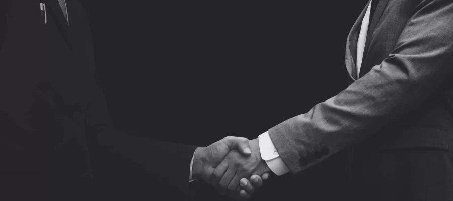 business-partners-shaking-hands-monochrome